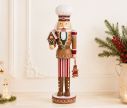 Voir la slide Figurine casse-noisette Théodore H46cm, costume pain d’épices brun rouge et blanc, maison de pain d’épices, rouleau