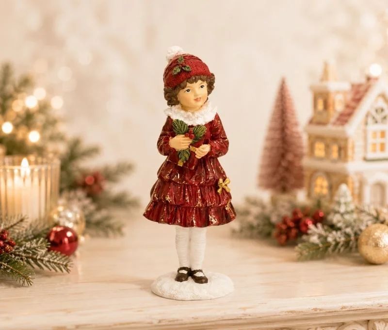 Figurine enfant fille Noël poly robe rouge bordeaux dorée volants col blanc bonnet rouge houx bouquet socle neige H17cm