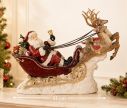 Voir la slide Décoration de Noël Père Noël traîneau rouge doré deux rennes cadeaux socle neigeux L42xl14xH36cm