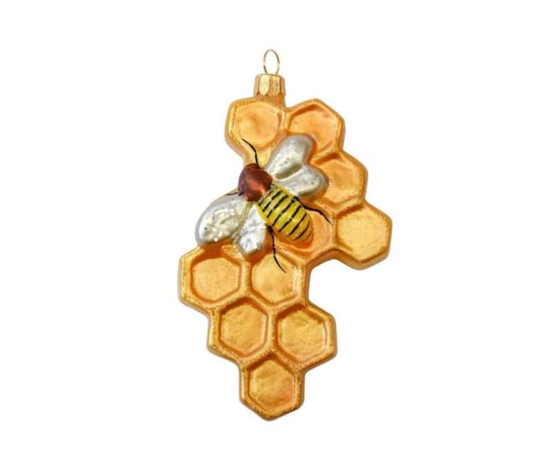 Boule de Noël originale nid d'abeille en verre soufflé avec petite abeille peinte à la main. Tons dorés. Hauteur 12cm.