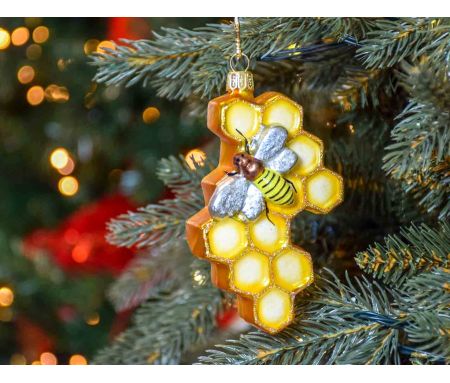 Boule de Noël originale nid d'abeille en verre soufflé avec petite abeille peinte à la main. Tons dorés. Hauteur 12cm.