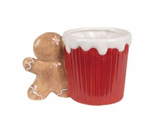 Mug de Noël rouge avec bonbons et anse en forme de pain d'épice.