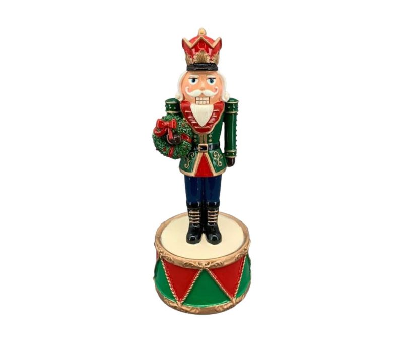 Boîte à musique résine casse-noisette veste verte couronne rouge couronne houx socle tambour rouge vert H22cm